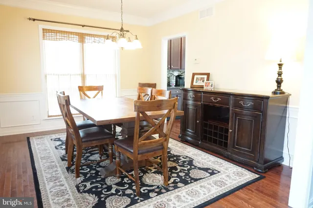 a dining room with a table and chairs