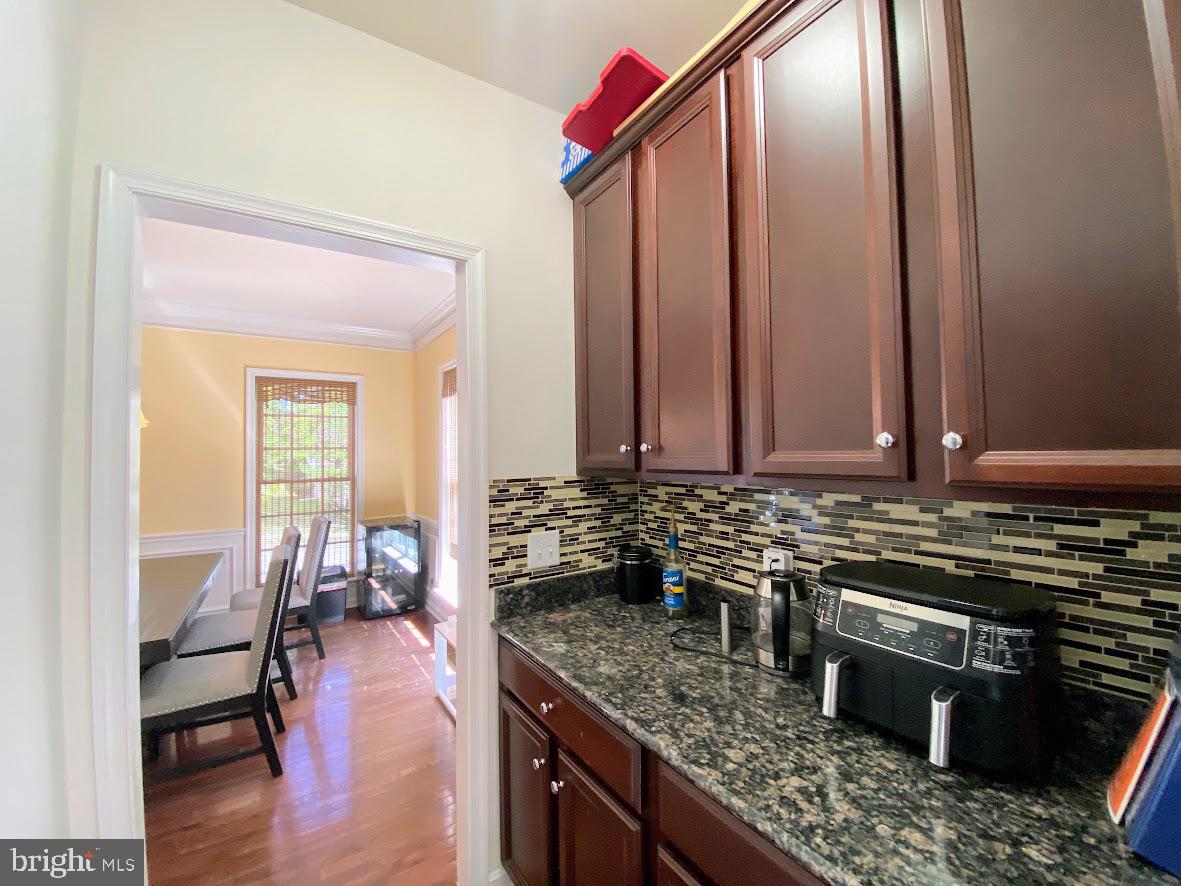 1403 Hampshire Lane Chester Springs, PA 19425 - Photo 6 of 31 a kitchen with stainless steel appliances granite countertop a stove a sink and a wooden cabinets