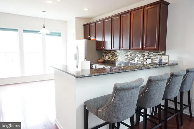 a kitchen with a table and chairs in it