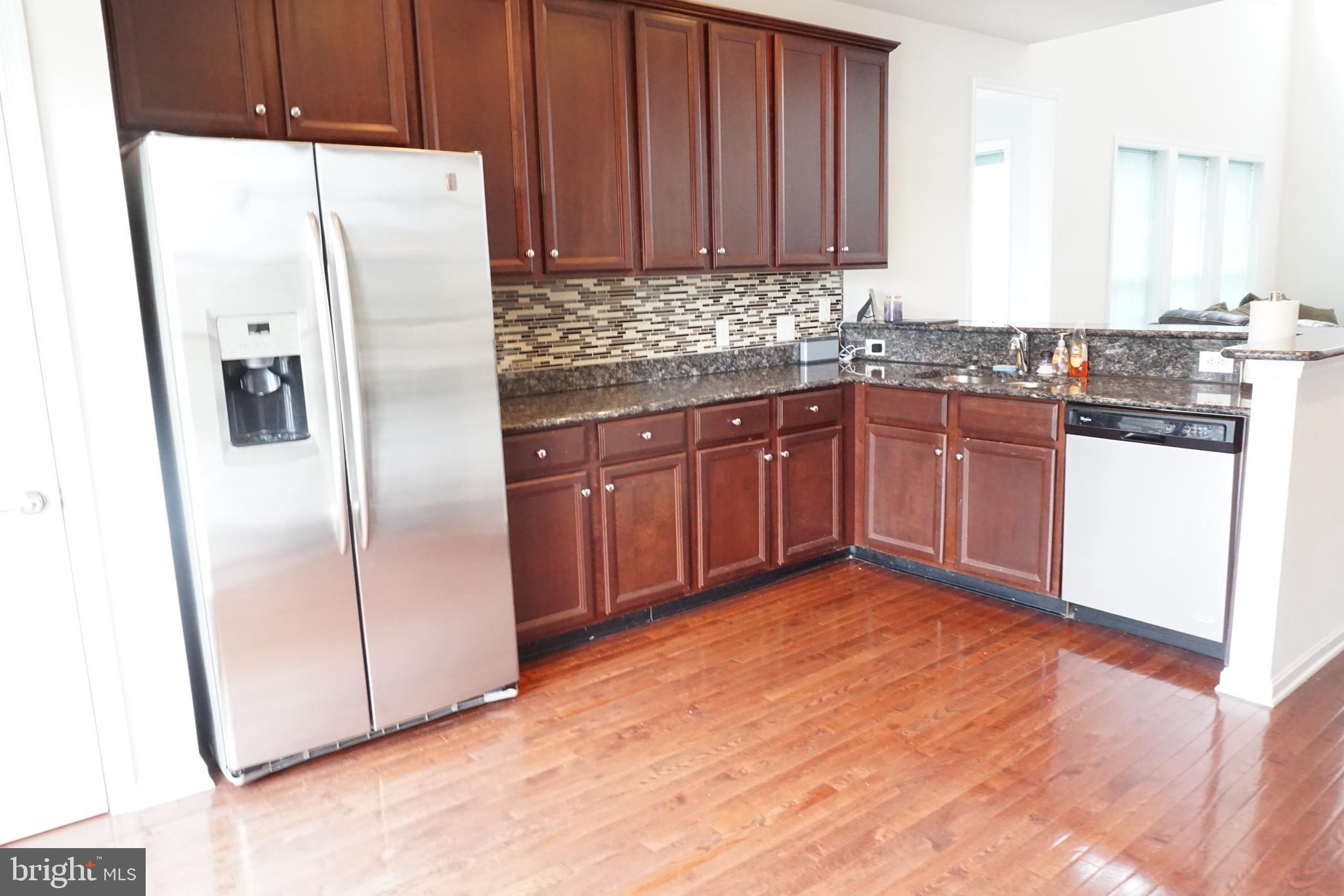 1403 Hampshire Lane Chester Springs, PA 19425 - Photo 9 of 31 a kitchen with granite countertop a refrigerator and a sink