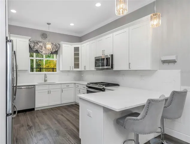 a kitchen with a stove a sink and a refrigerator
