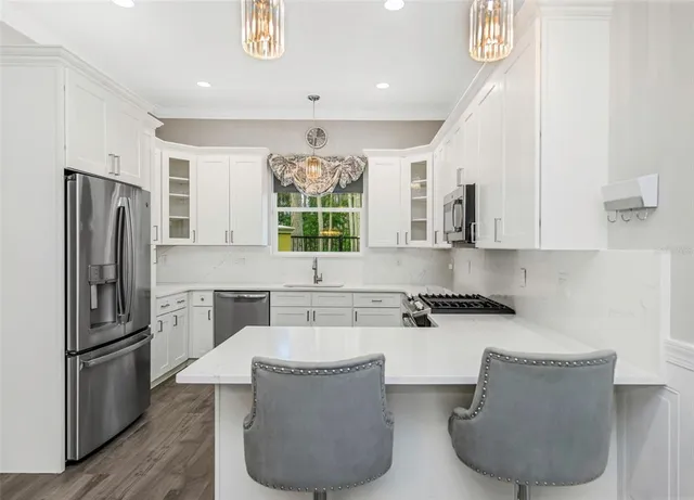 a kitchen with a refrigerator sink and wooden cabinets