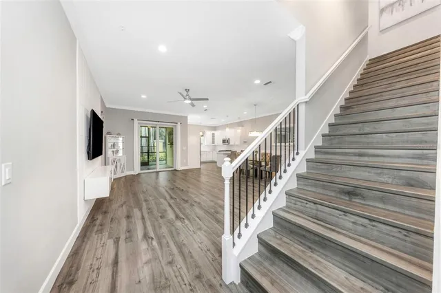 a hallway with wooden floor and windows