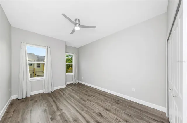 a view of an empty room with wooden floor