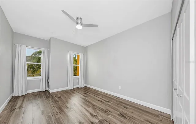 a bathroom with a granite countertop sink a toilet a mirror a vanity and shower