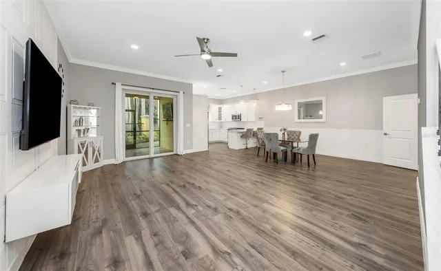 a view of a livingroom with furniture wooden floor and chandelier