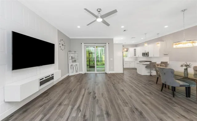 a living room with furniture wooden floor and a flat screen tv