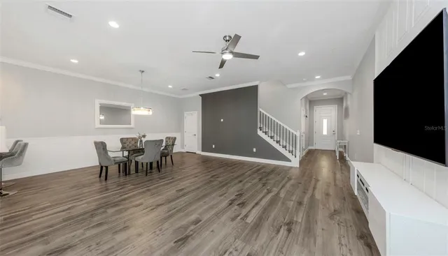 a view of a dining room with furniture and chandelier