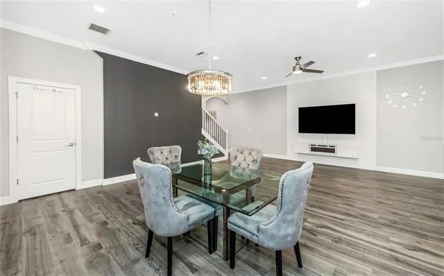 a view of a dining room with furniture and wooden floor