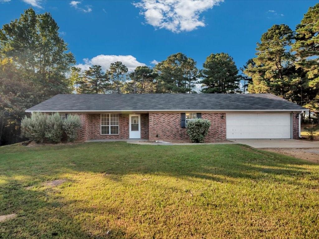 a view of a house with a backyard