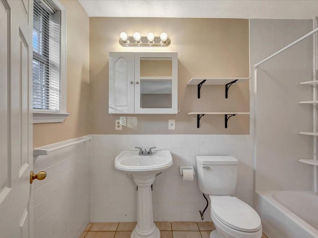 977 Farm To Market 347 Rusk, TX 75785 - Photo 19 of 33 a bathroom with a sink toilet and mirror