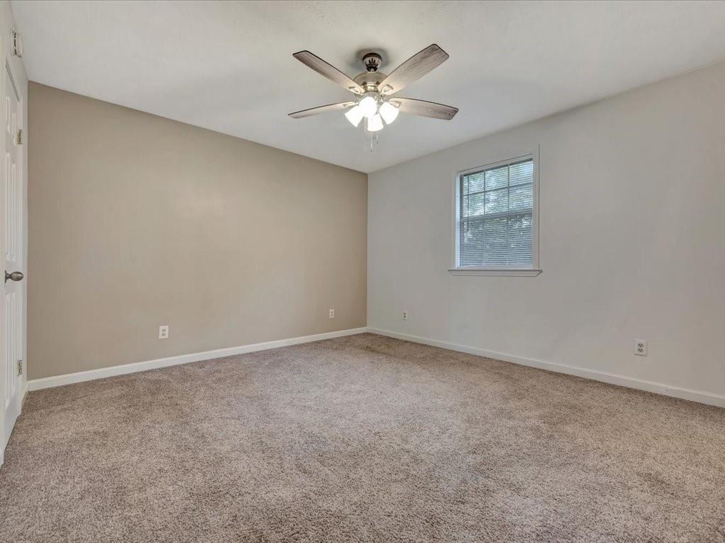 977 Farm To Market 347 Rusk, TX 75785 - Photo 21 of 33 an empty room with chandelier fan and windows