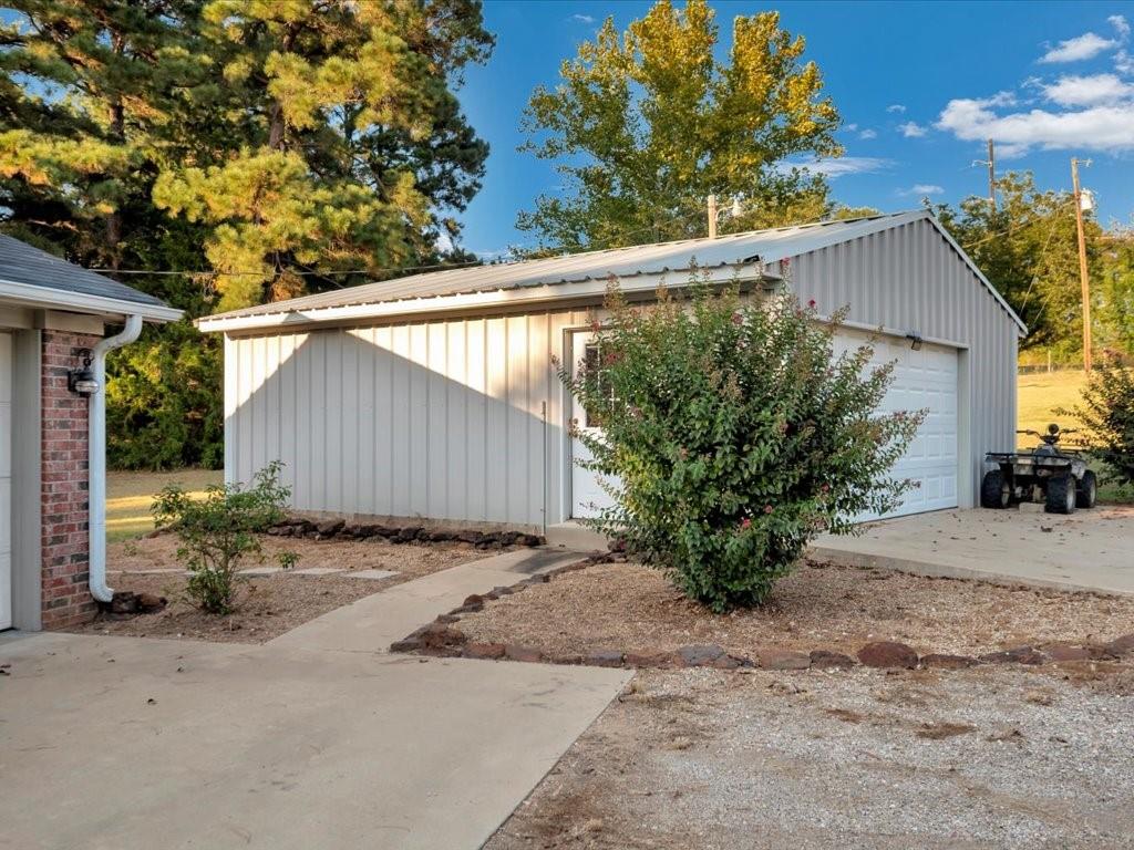 977 Farm To Market 347 Rusk, TX 75785 - Photo 30 of 33 a backyard of a house with plants and trees