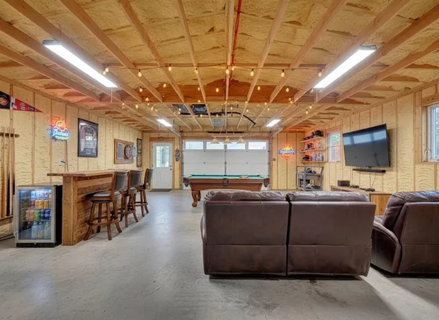 a living room with lots of furniture and chandelier