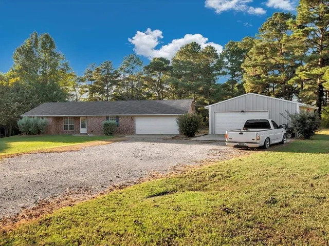 a house view with a swimming pool and a yard