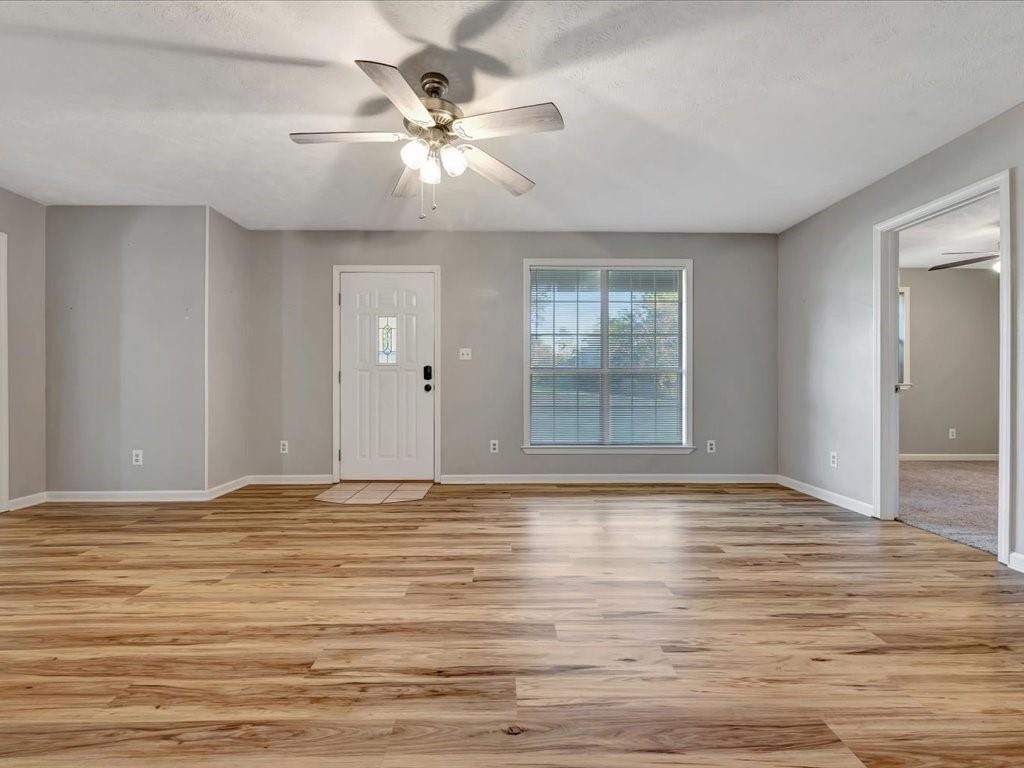 977 Farm To Market 347 Rusk, TX 75785 - Photo 8 of 33 a view of an empty room with wooden floor and a window