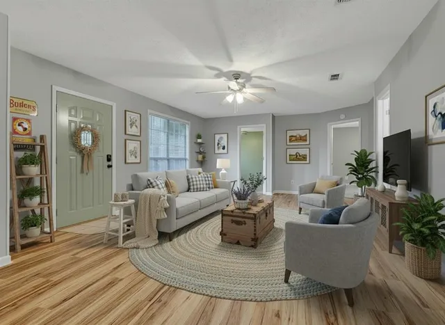 a living room with furniture and a flat screen tv