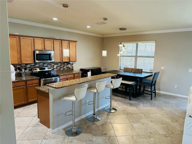a kitchen with a sink counter top space appliances and a window