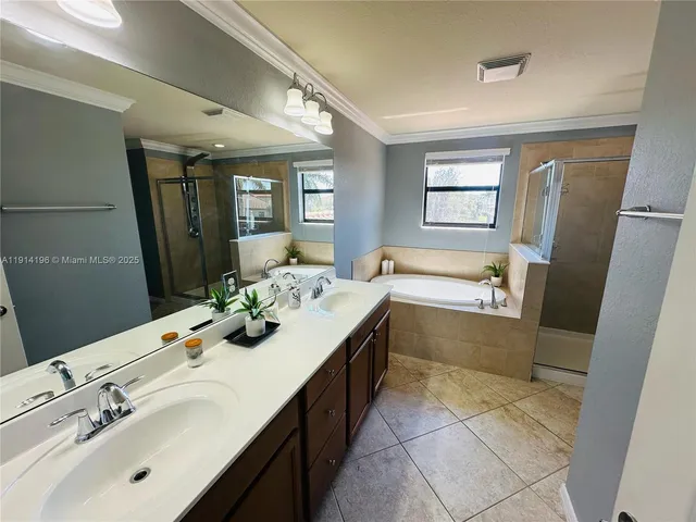 a bathroom with a tub sink and mirror