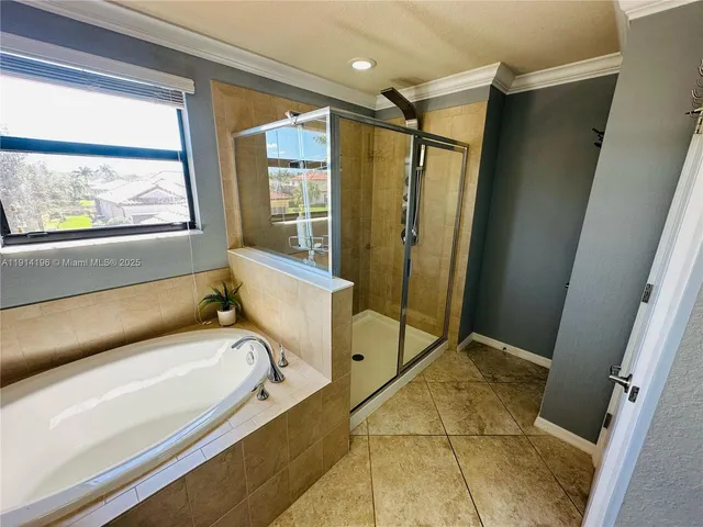 a bathroom with a tub and a shower