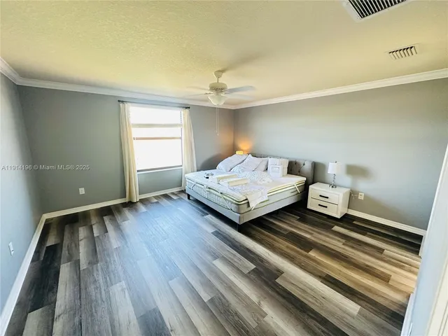 a spacious bedroom with a bed and a window