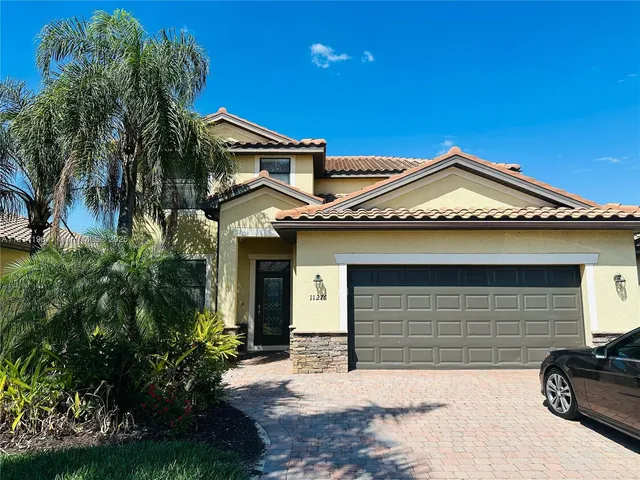 a front view of a house with a yard and garage