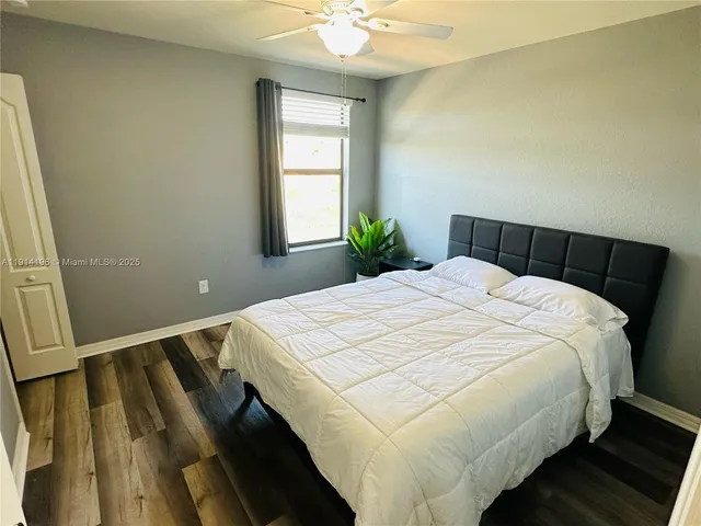 a bed sitting in a bedroom next to a window
