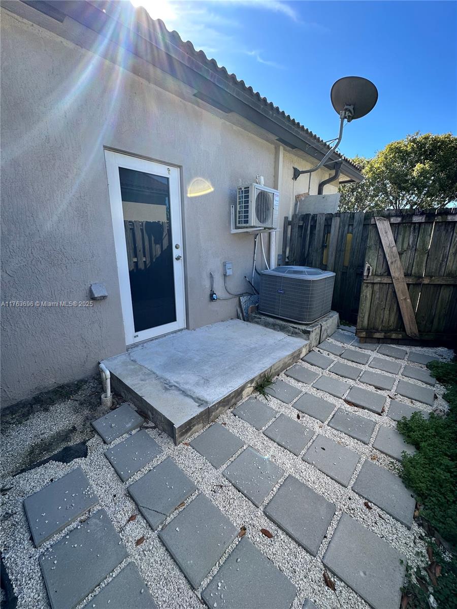 13137 Southwest 284th Street, Unit B Homestead, FL 33033 - Photo 11 of 11 a backyard of a house with table and chairs