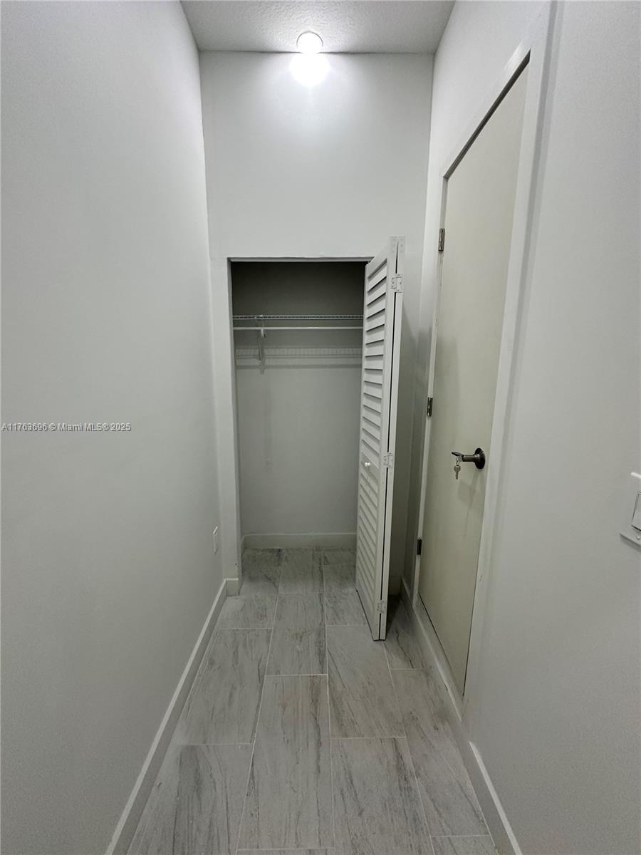 13137 Southwest 284th Street, Unit B Homestead, FL 33033 - Photo 3 of 11 an empty room with closet