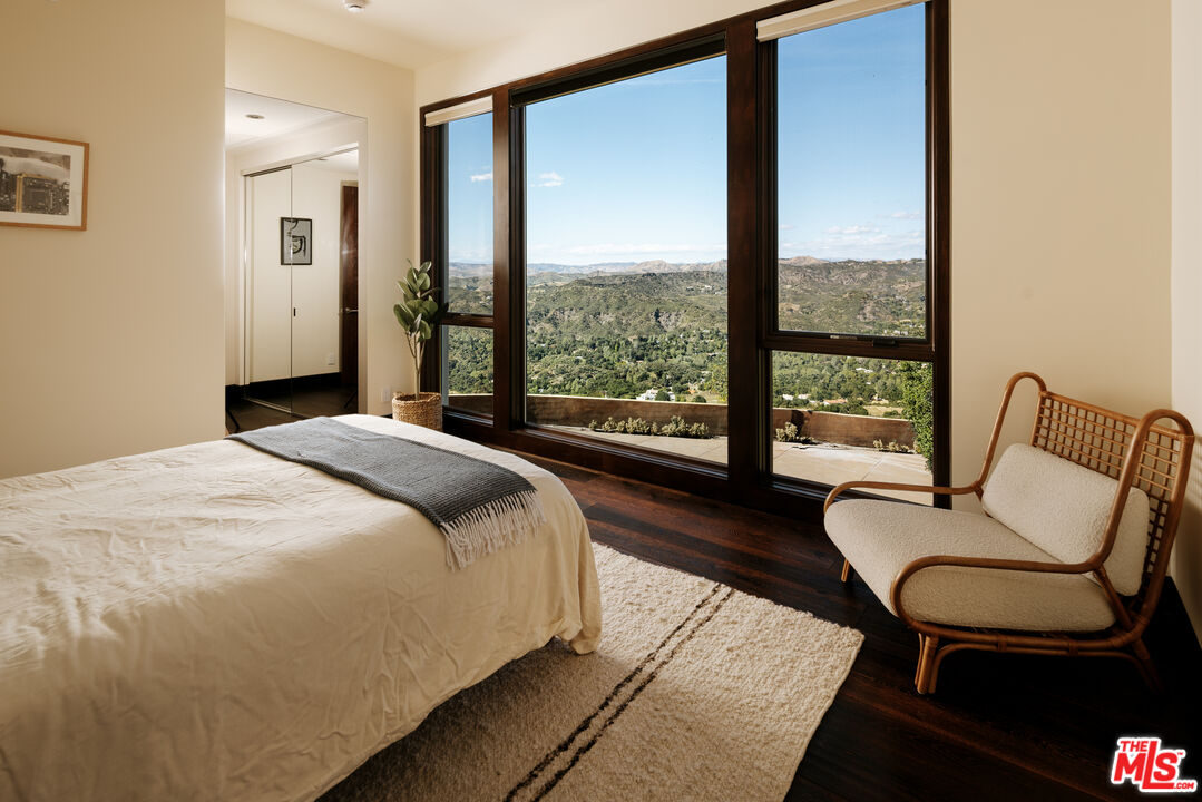 25155 Piuma Road Malibu, CA 90265 - Photo 11 of 23 a bedroom with a bed and a large window