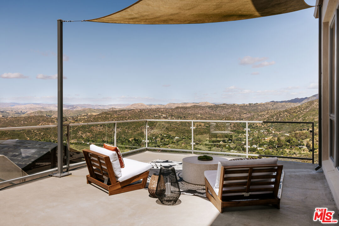 25155 Piuma Road Malibu, CA 90265 - Photo 17 of 23 a roof deck with a couple of chairs