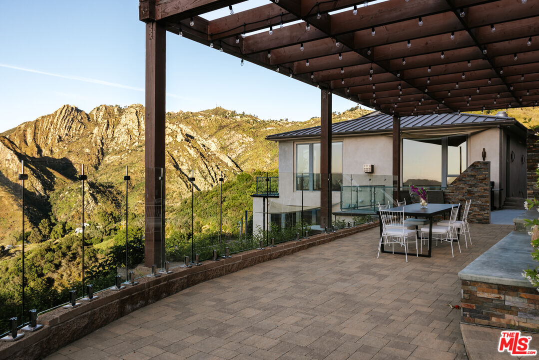 25155 Piuma Road Malibu, CA 90265 - Photo 21 of 23 a view of a patio with table and chairs and potted plants