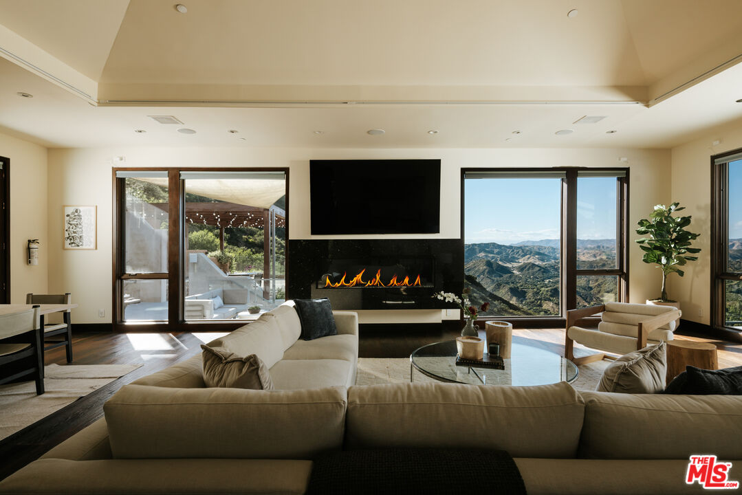 25155 Piuma Road Malibu, CA 90265 - Photo 3 of 23 a living room with furniture and a flat screen tv