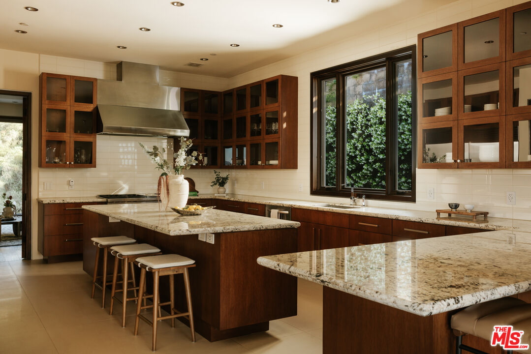 25155 Piuma Road Malibu, CA 90265 - Photo 4 of 23 a kitchen with stainless steel appliances granite countertop a sink and a stove