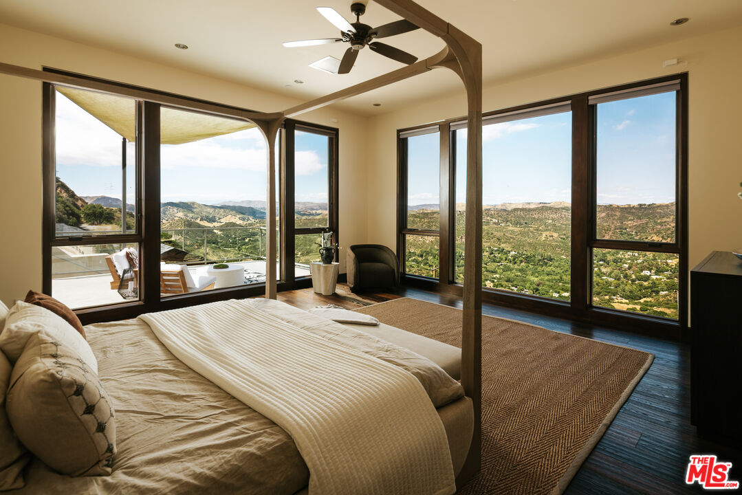 25155 Piuma Road Malibu, CA 90265 - Photo 6 of 23 a bed sitting in a bedroom next to a large window