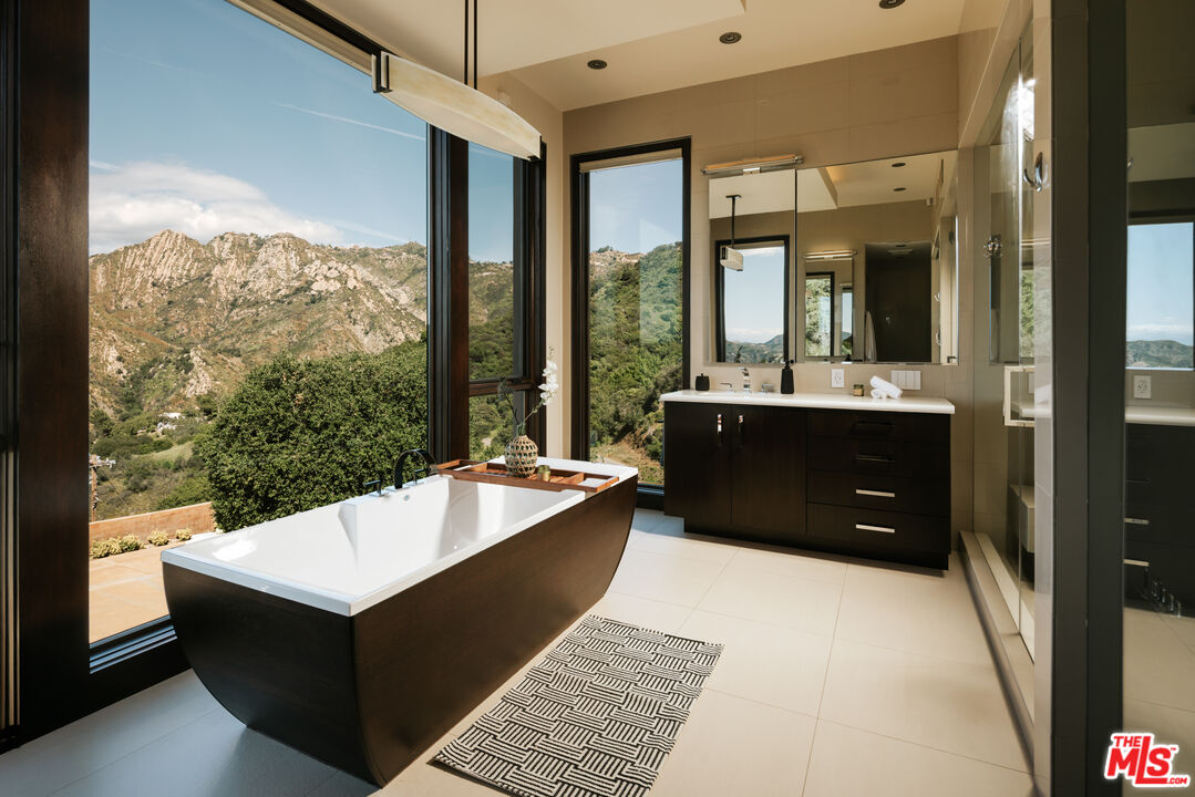 25155 Piuma Road Malibu, CA 90265 - Photo 7 of 23 a living room with a large window and a table