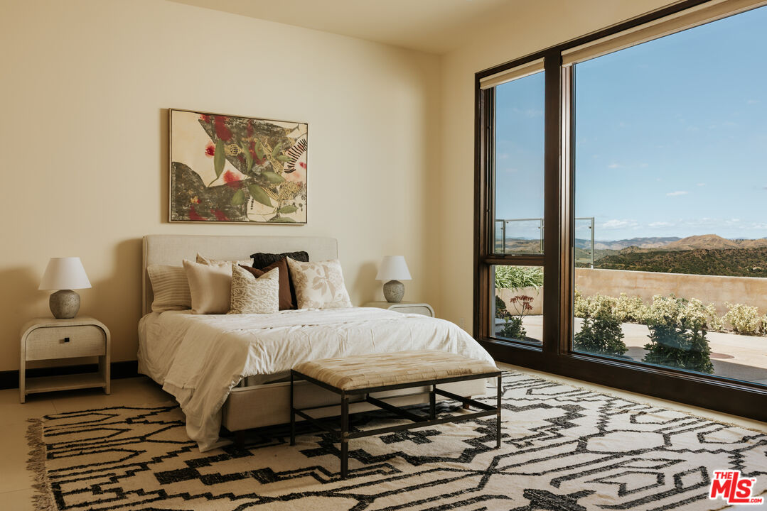 25155 Piuma Road Malibu, CA 90265 - Photo 9 of 23 a bedroom with a bed painting on wall and a large window