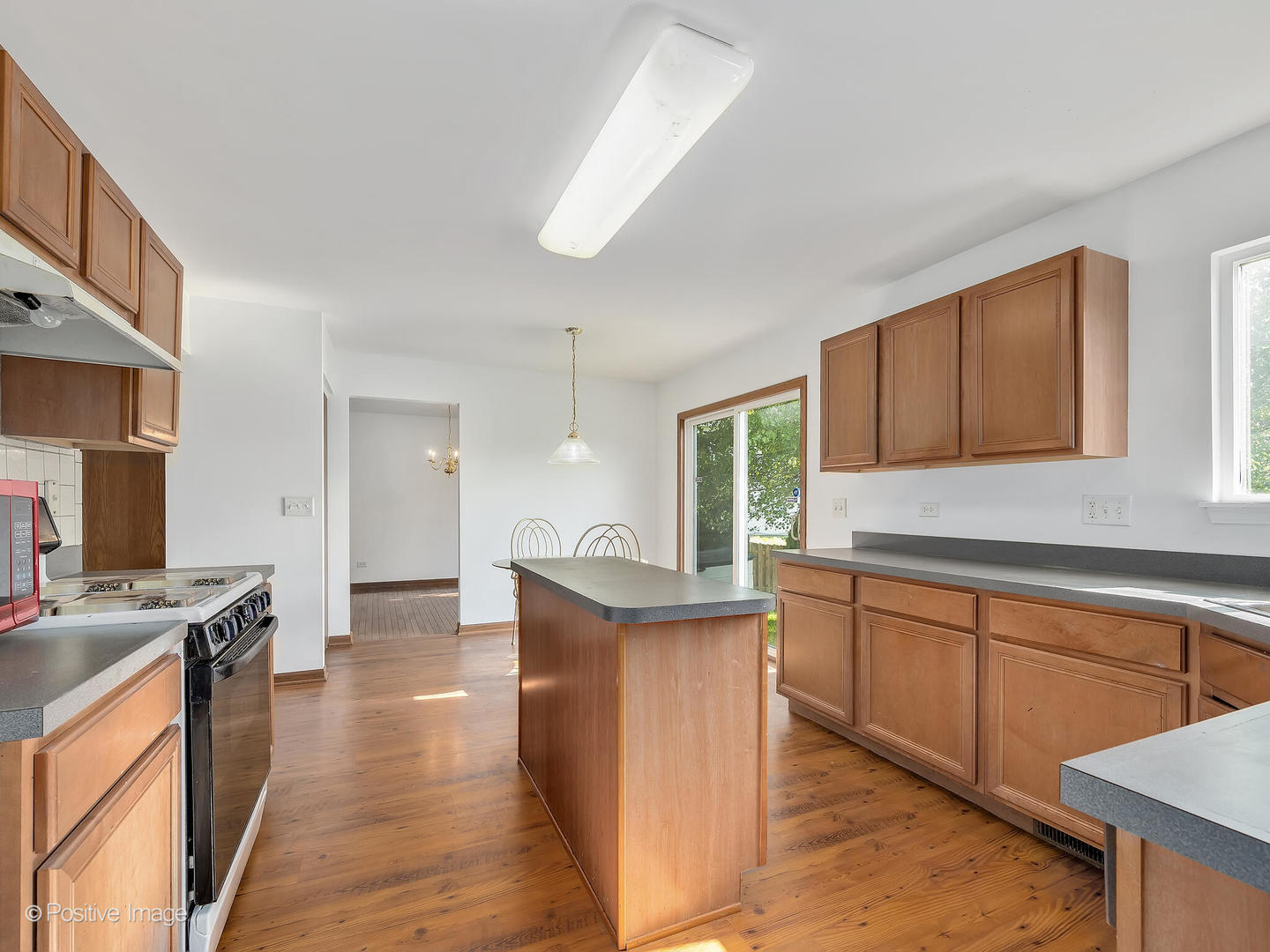 215 Berkeley Drive Bolingbrook, IL 60440 - Photo 11 of 28 a kitchen with stainless steel appliances granite countertop a sink stove and refrigerator