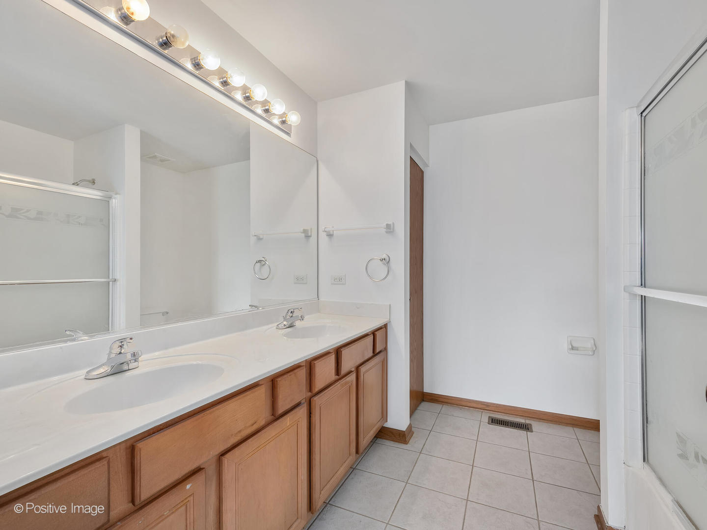215 Berkeley Drive Bolingbrook, IL 60440 - Photo 20 of 28 a bathroom with a double vanity sink and a mirror