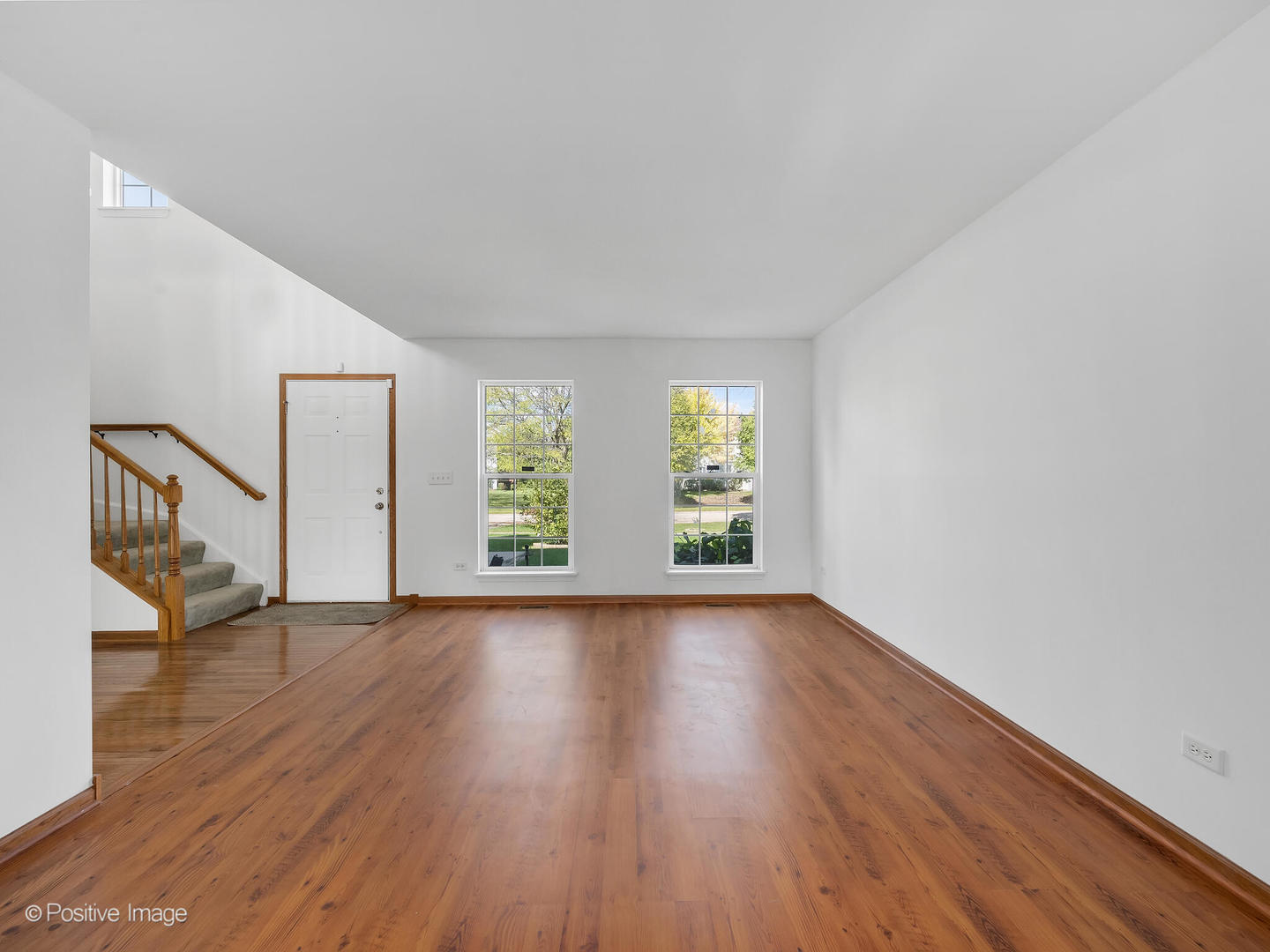 215 Berkeley Drive Bolingbrook, IL 60440 - Photo 4 of 28 an empty room with wooden floor and windows