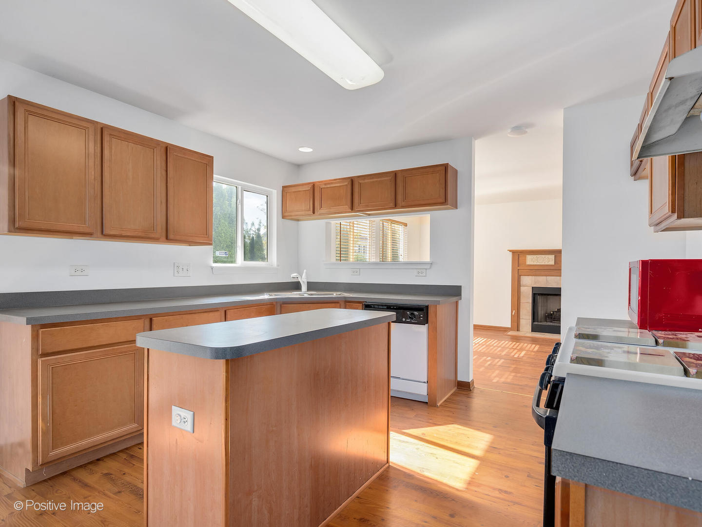 215 Berkeley Drive Bolingbrook, IL 60440 - Photo 10 of 28 a kitchen with kitchen island a stove a sink and a refrigerator