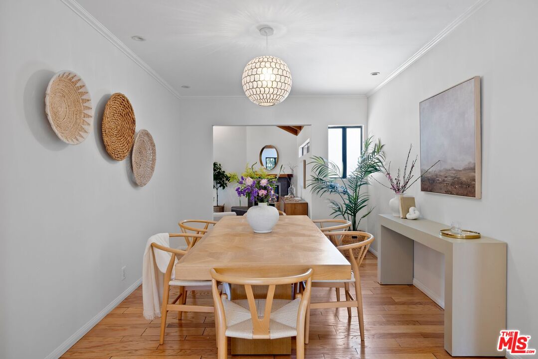 4908 Ramsdell Avenue La Crescenta, CA 91214 - Photo 11 of 29 a view of a dining room with furniture a chandelier and wooden floor