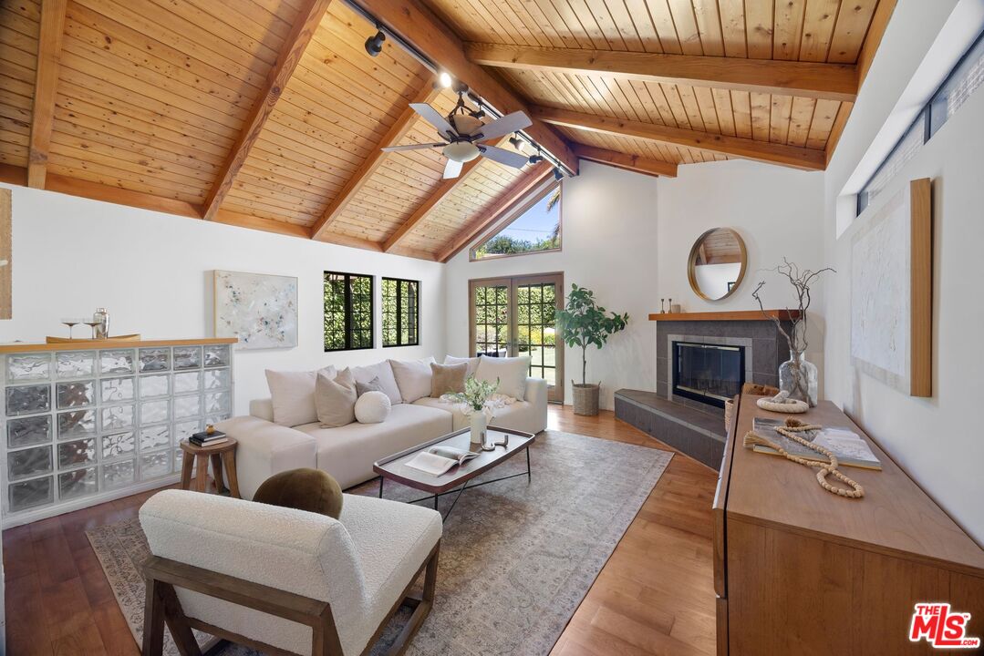 4908 Ramsdell Avenue La Crescenta, CA 91214 - Photo 13 of 29 a living room with furniture a fireplace and a flat screen tv