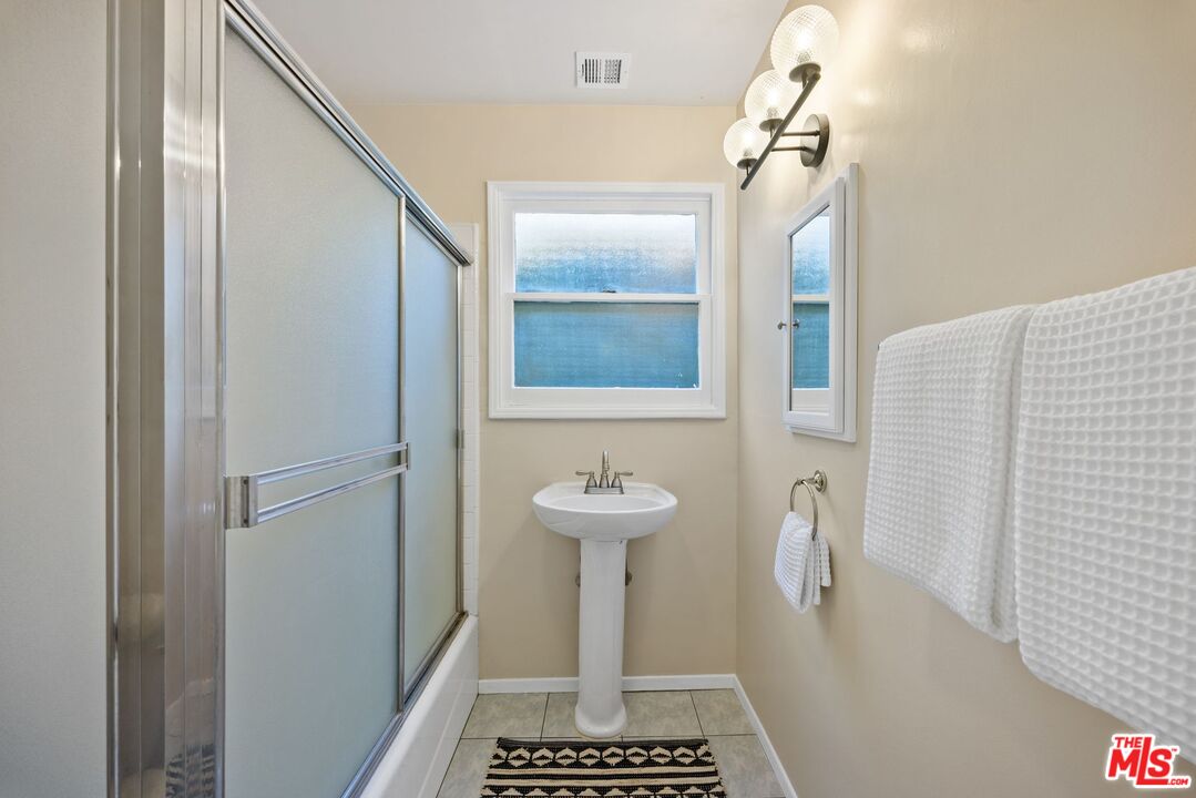 4908 Ramsdell Avenue La Crescenta, CA 91214 - Photo 20 of 29 a bathroom with a sink a toilet and a mirror