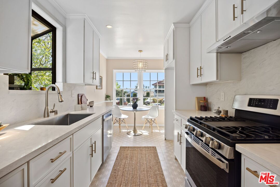 4908 Ramsdell Avenue La Crescenta, CA 91214 - Photo 8 of 29 a kitchen with granite countertop a sink stove and cabinets