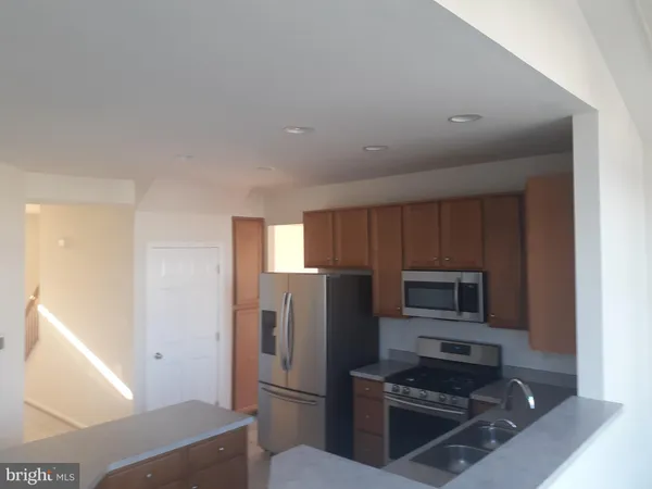 a kitchen with a refrigerator stove and microwave