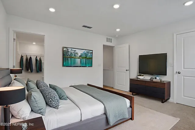 a bedroom with a bed and a flat screen television