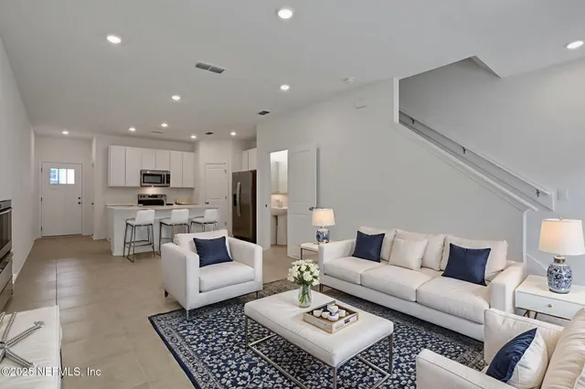 a living room with furniture and a rug
