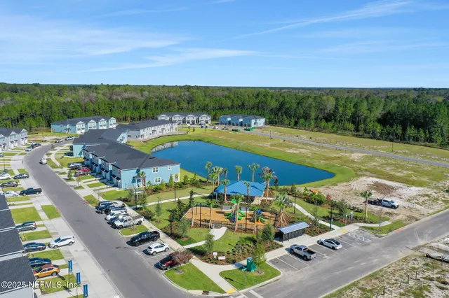 an aerial view of a house with outdoor space swimming pool and lake view