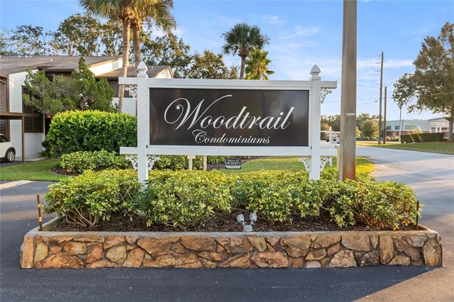 a kitchen with stainless steel appliances granite countertop a stove a sink dishwasher a refrigerator and cabinets with wooden floor